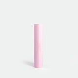 A bright pink tube on a white background, showcasing its bold hue and simple design