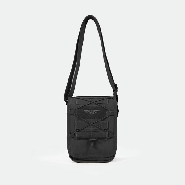 A small, black crossbody shoulder bag with an adjustable strap, front elastic cord, and a subtle logo on the front, displayed against a plain light gray background.