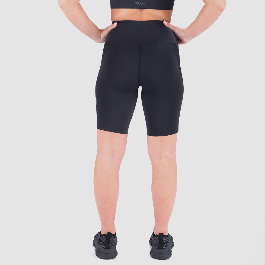 a back view for fit woman wearing seamless  short black with shoes black ,plus the background is light grey 