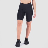 a fit woman wearing seamless  short black with shoes black ,plus the background is light grey 