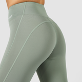 a back view for woman  stand 
 demi- quarter pose ,she  wearing legging olive with logo white ,plus the background is light grey 