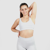 a woman wearing matching grey bra and legging  ,with background  light grey  