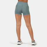 a back view for fit woman wearing short blue with shoes ,plus the background is light grey 