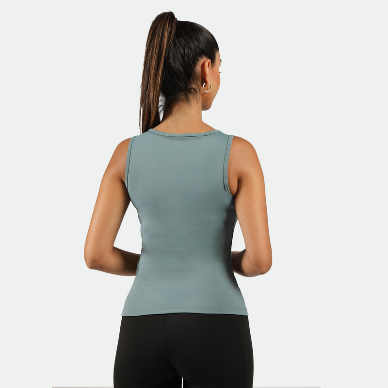 a back view for fit woman wearing tank green with legging black 