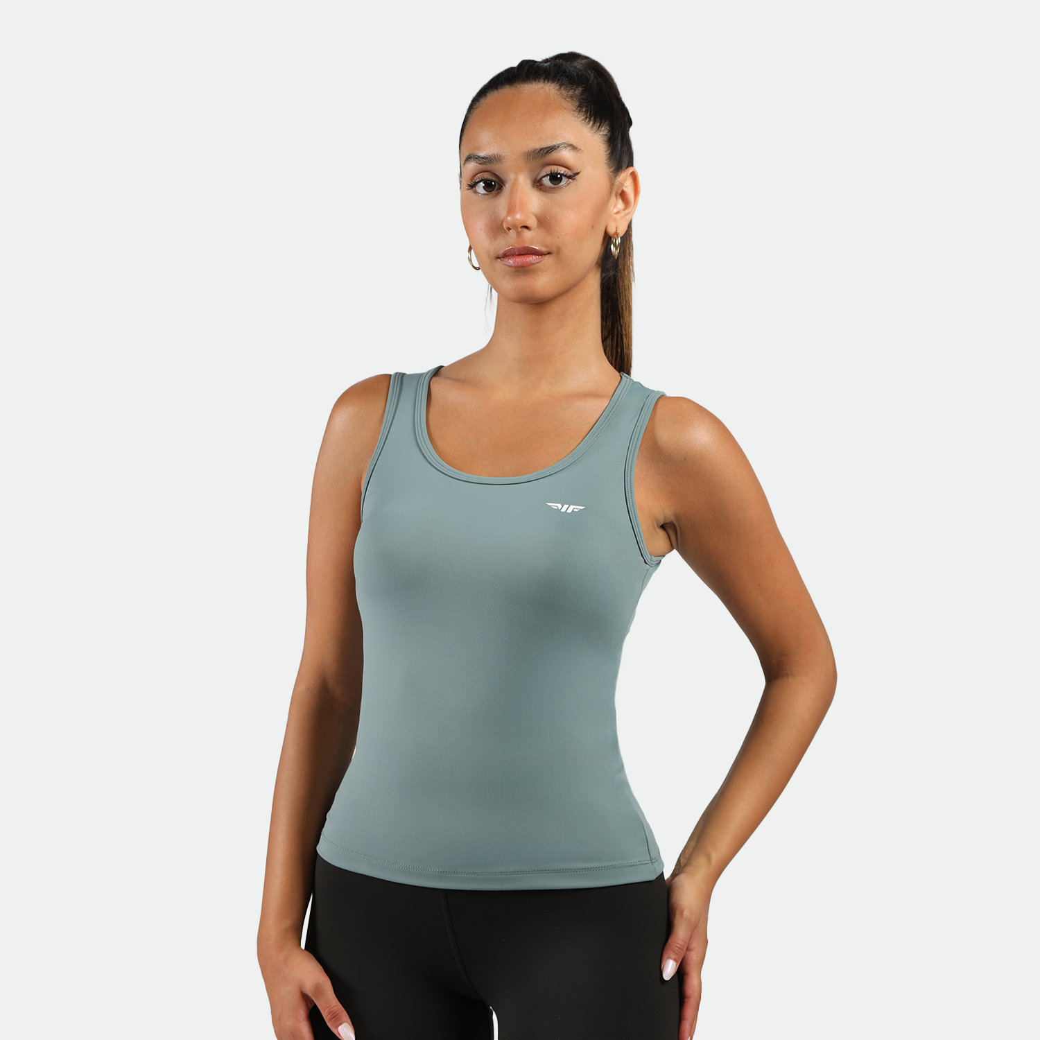 a fit woman wearing  tank green with legging black 