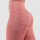 a back view for woman wearing  camo orange legging with logo white ,plus the background is light grey 