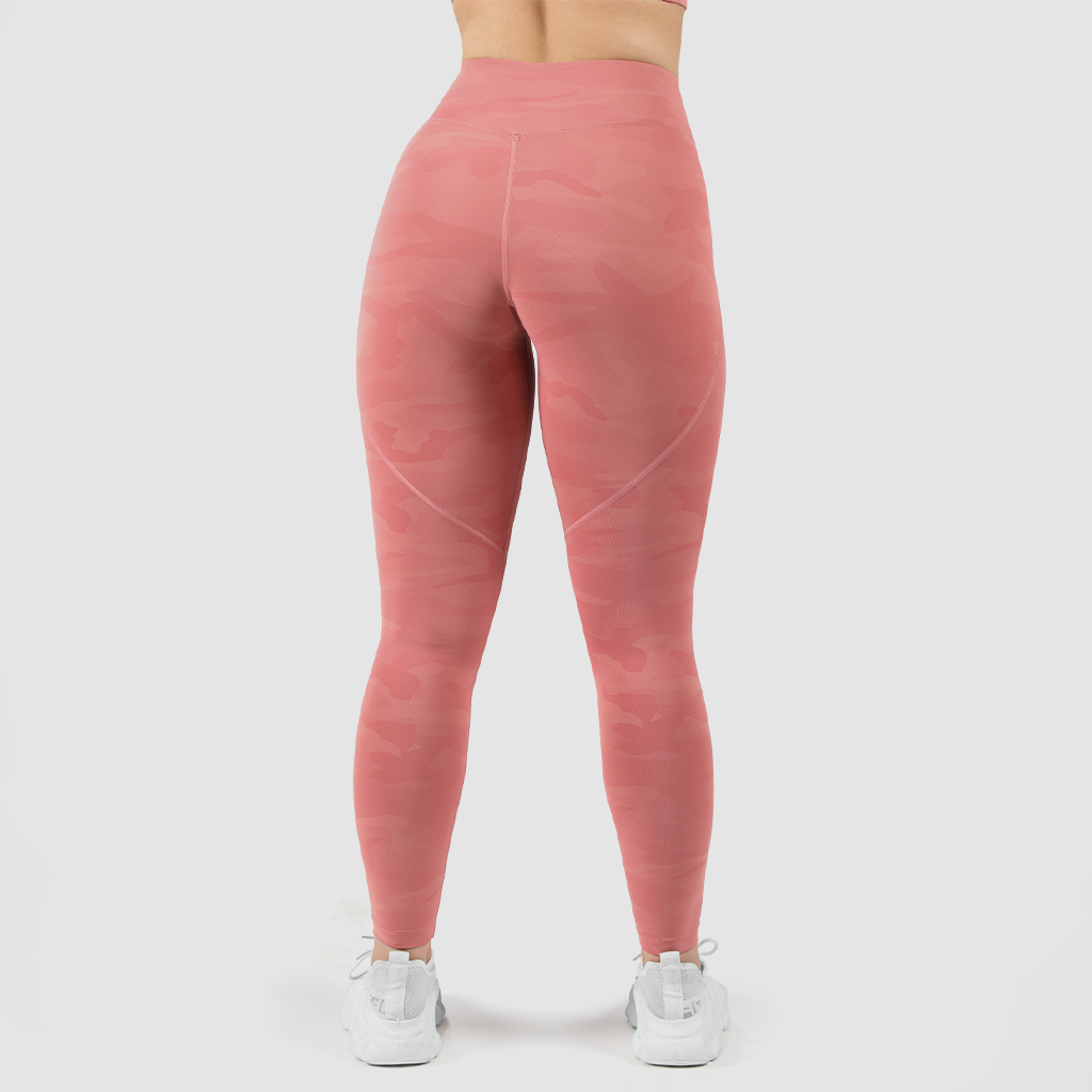 a back view for fit woman wearing camo orange legging and shoes white ,plus the background is light grey 