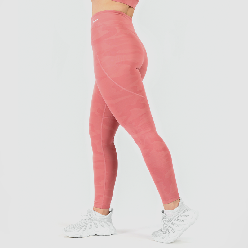 a woman she stand at right and wearing camo orange  legging logo  and shoes white , plus the background  light grey 