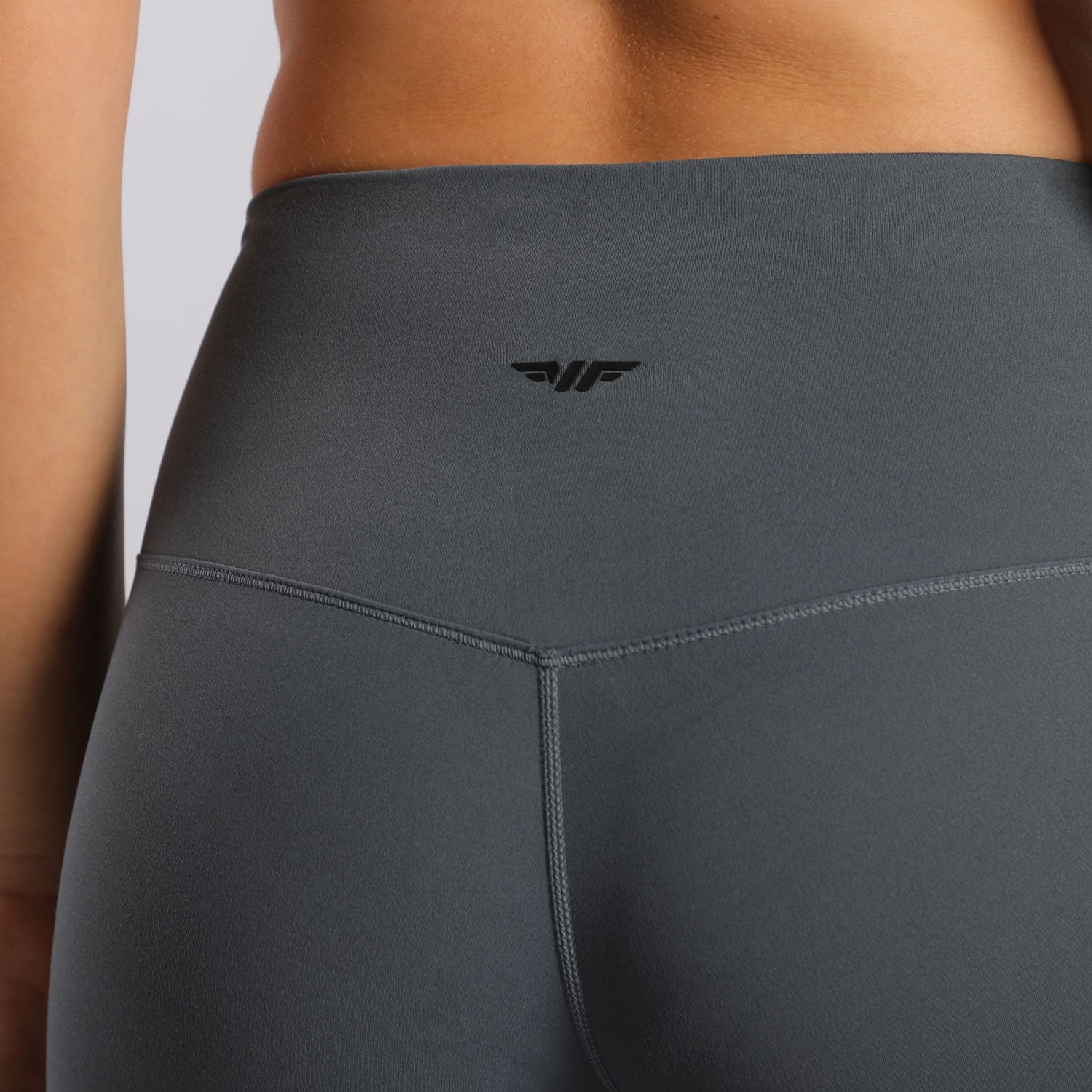 close up view for back view of woman wearing legging grey with logo