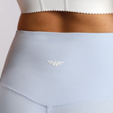 close up view for fit woman wearing legging sky blue with logo 
