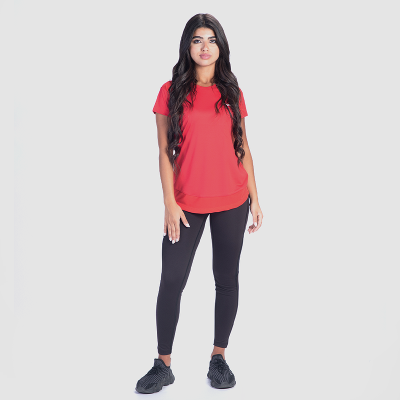 a fit woman wearing t-shirt red with legging black and sneakers