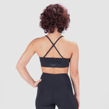  a back view  for women  wearing  matching bras and leggings  black ,the bras  have logo in half  , plus have  designer x