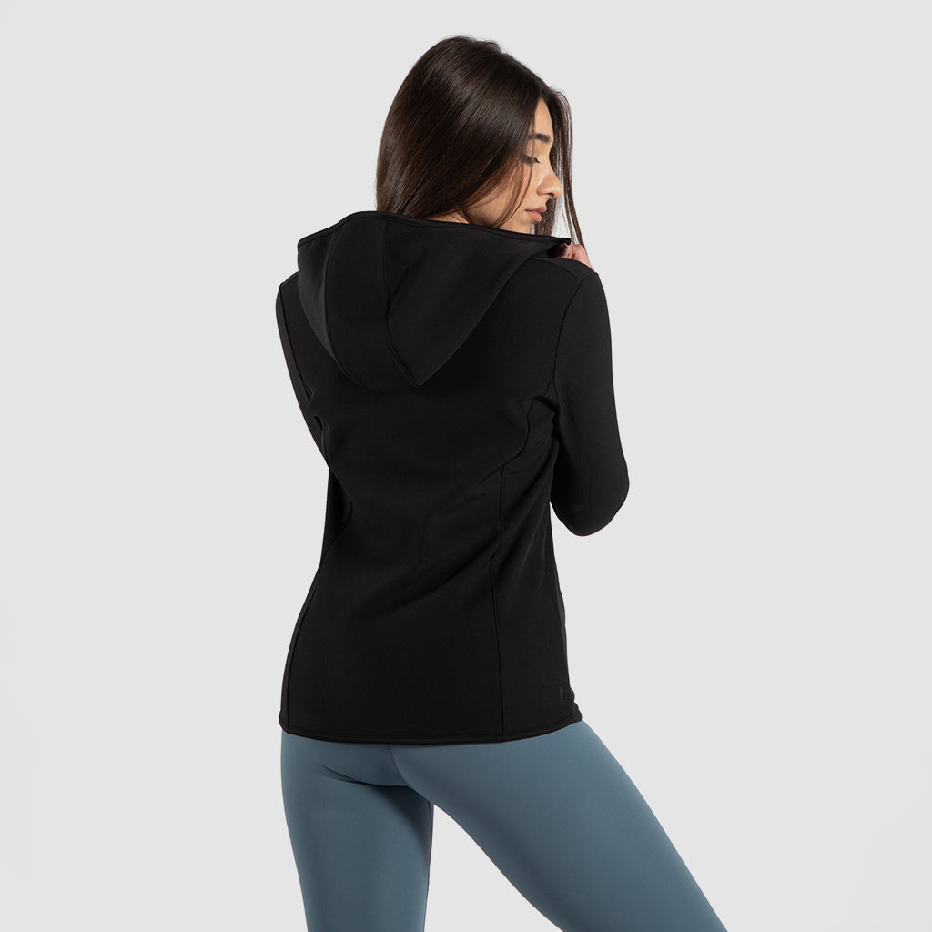 a back view for fit woman wearing jacket black with legging green 