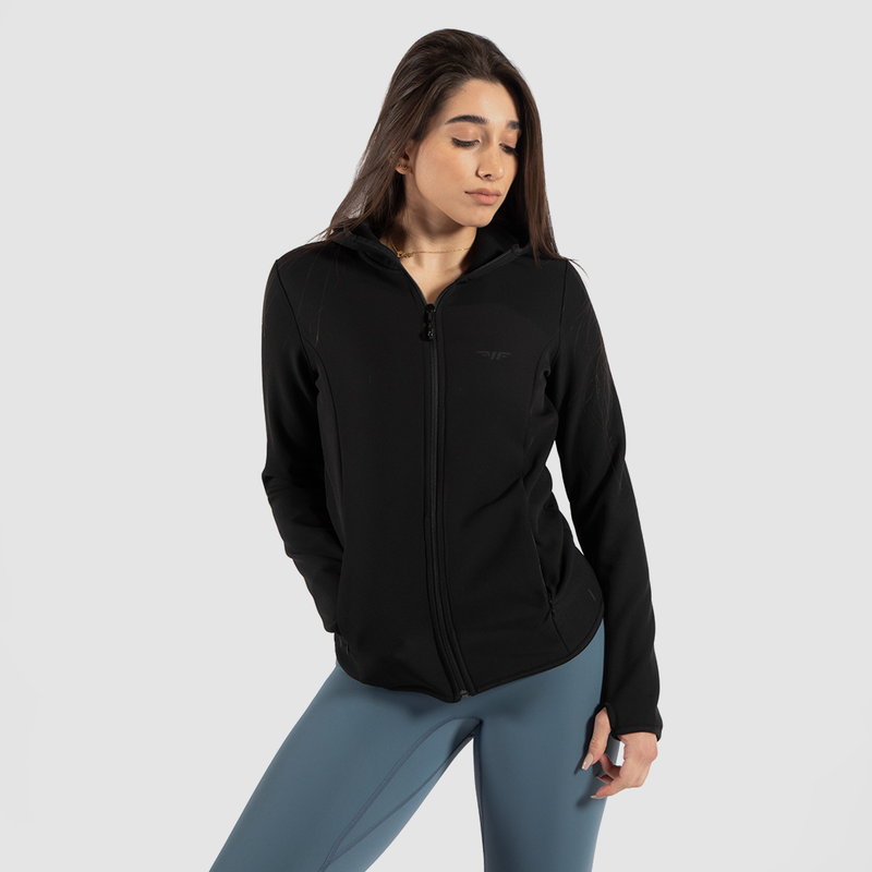 a fit woman wearing jacket black with legging green 
