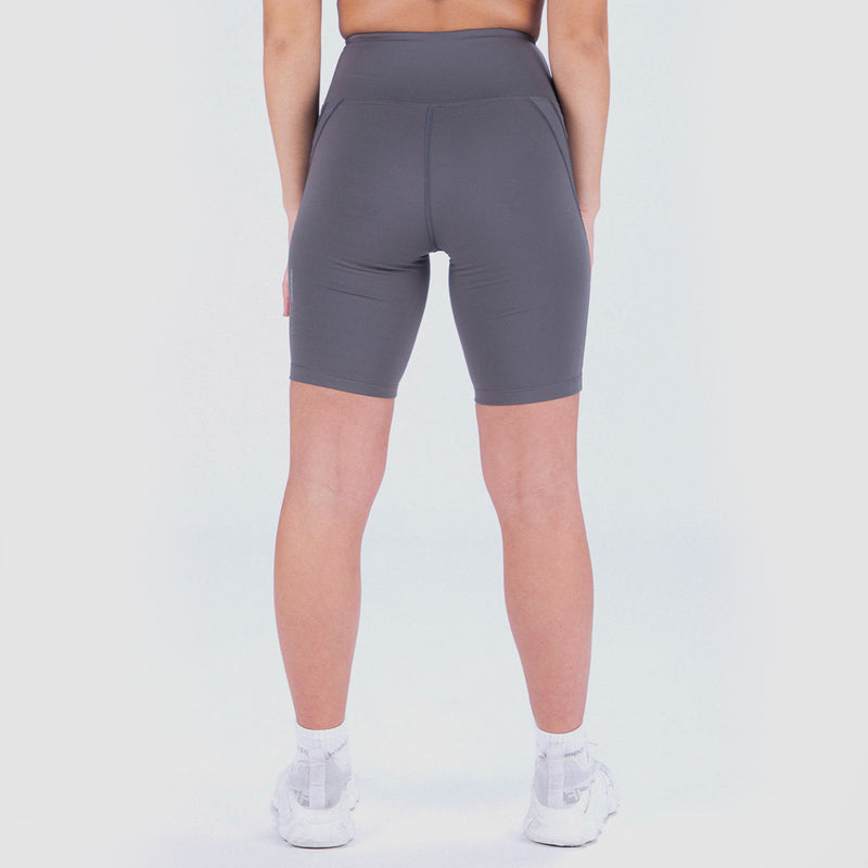 a back view for fit woman wearing seamless short grey with shoes white ,plus the background is light grey 