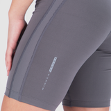 Close-up of someone wearing gray compression shorts with vertical striped detail. The words "Winner Force" are visible, suggesting a sporty, active vibe.