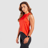 a fit woman stand at right and wearing tank candy red with  legging black 