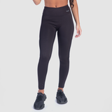 a fit woman wearing legging black with logo  and sneakers 