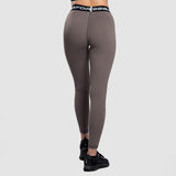 a back view for fit woman wearing  legging brown with shoes black 