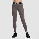 a fit woman wearing legging  brown with sneakers  black 
