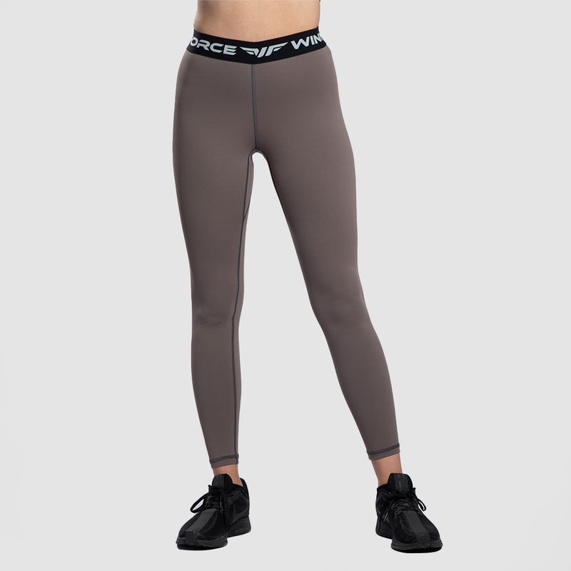a fit woman wearing legging  brown with sneakers  black 