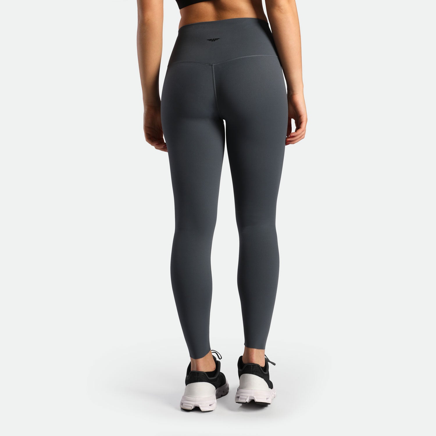 a back view for woman wearing legging grey with shoes black 
