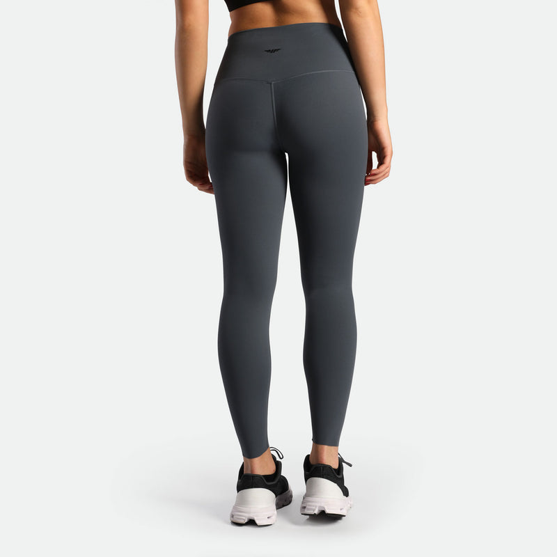 a back view for woman wearing legging grey with shoes black 