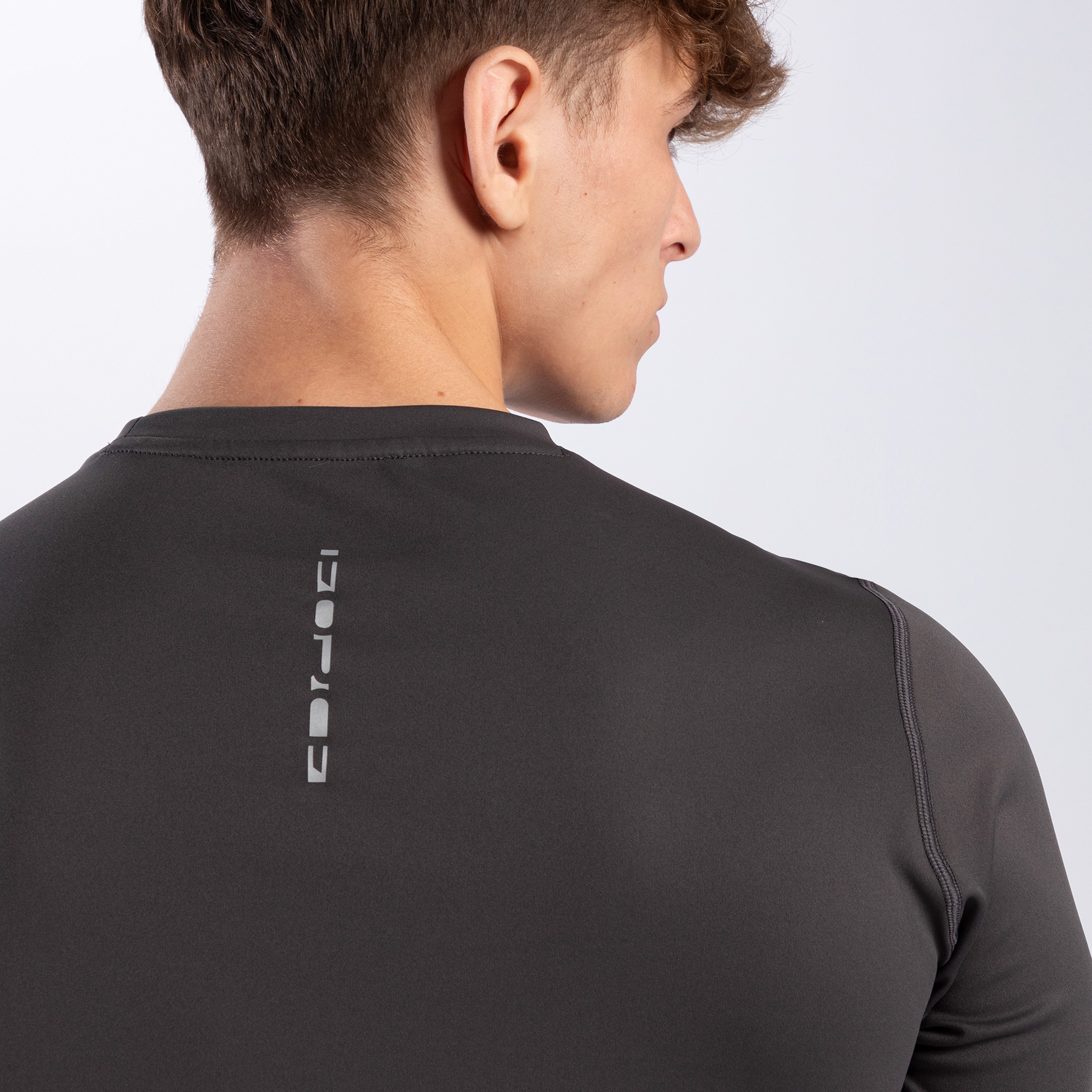 A close-up of the word FORCE written on a t-shirt of color iron dark grey
