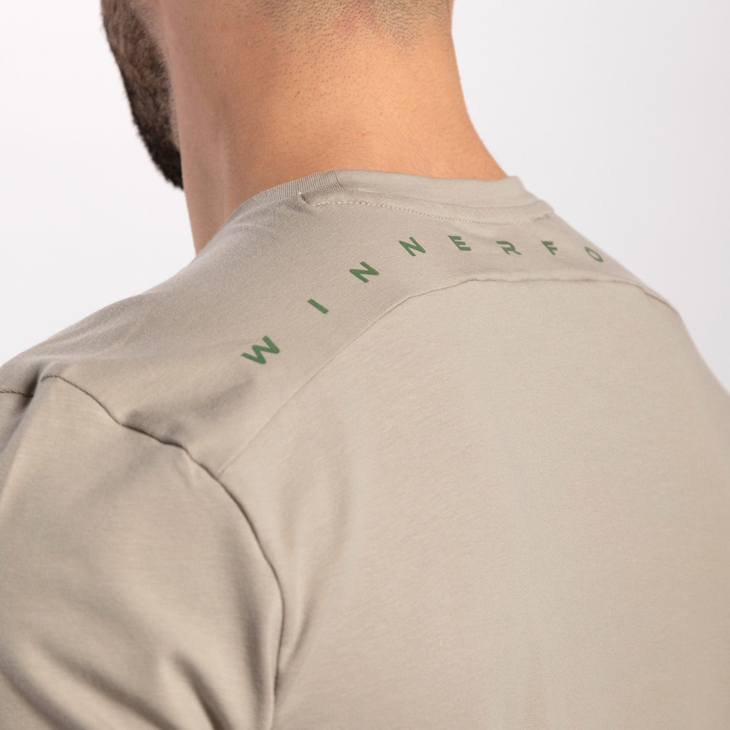 close up view for back view of man wearing t-shirt agate grey with logo 