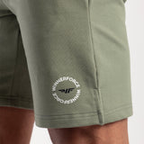 Close-up of green shorts with logo 