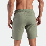 a back view for fit man wearing short agave green 