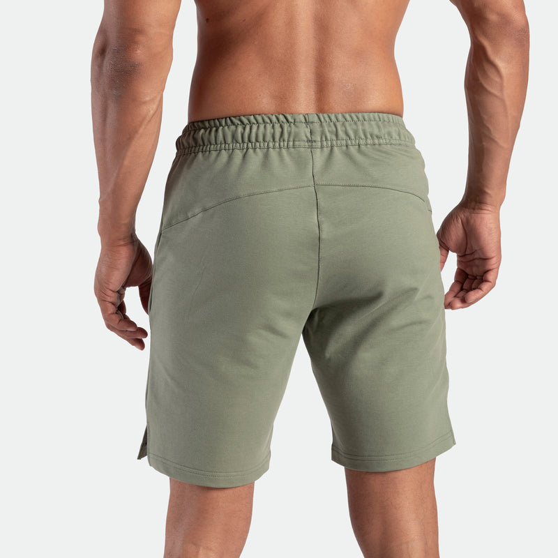 a back view for fit man wearing short agave green 