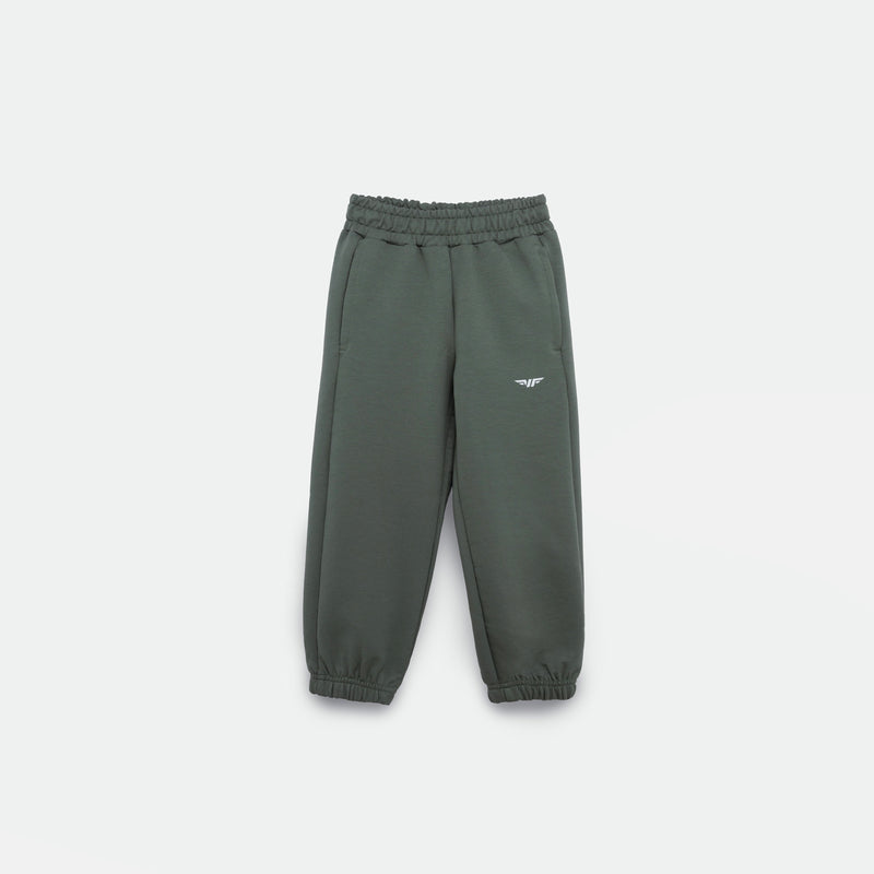 AGAVE-GREEN JOGGER PANT FOR GIRL with an elastic waistband and cuffs, featuring a small white logo (WINNER FORCE) on the left thigh, displayed against a plain light background.