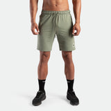 a fit man wearing short agave green with socks and shoes black 