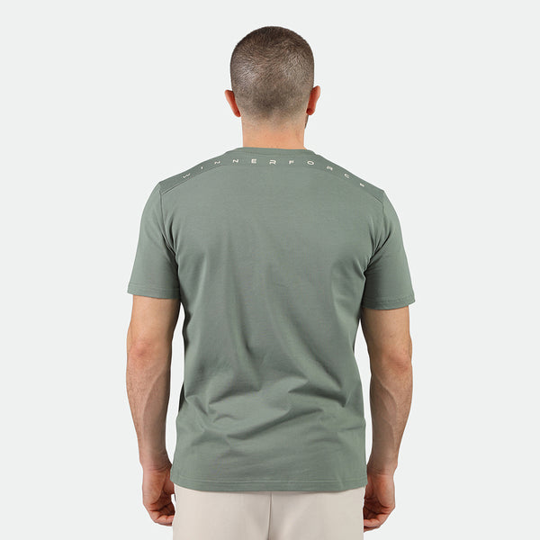 a back view for fit man wearing t-shirt agave green and pants beige 