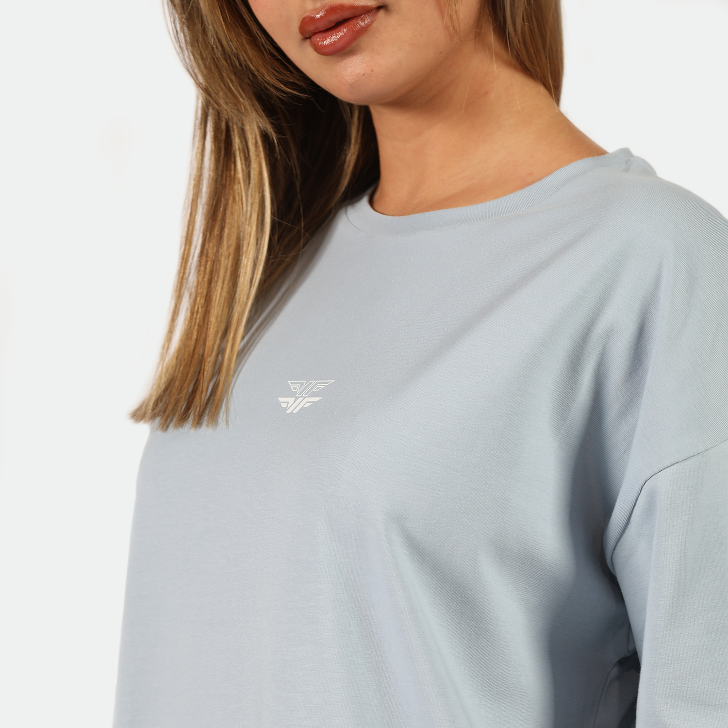 close up view for fit woman wearing t-shirt blue  with logo 