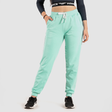 a fit woman wearing pants aqua with sneakers black  