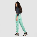 a back view for fit woman wearing crop top black with pants  aqua and  sneakers black 