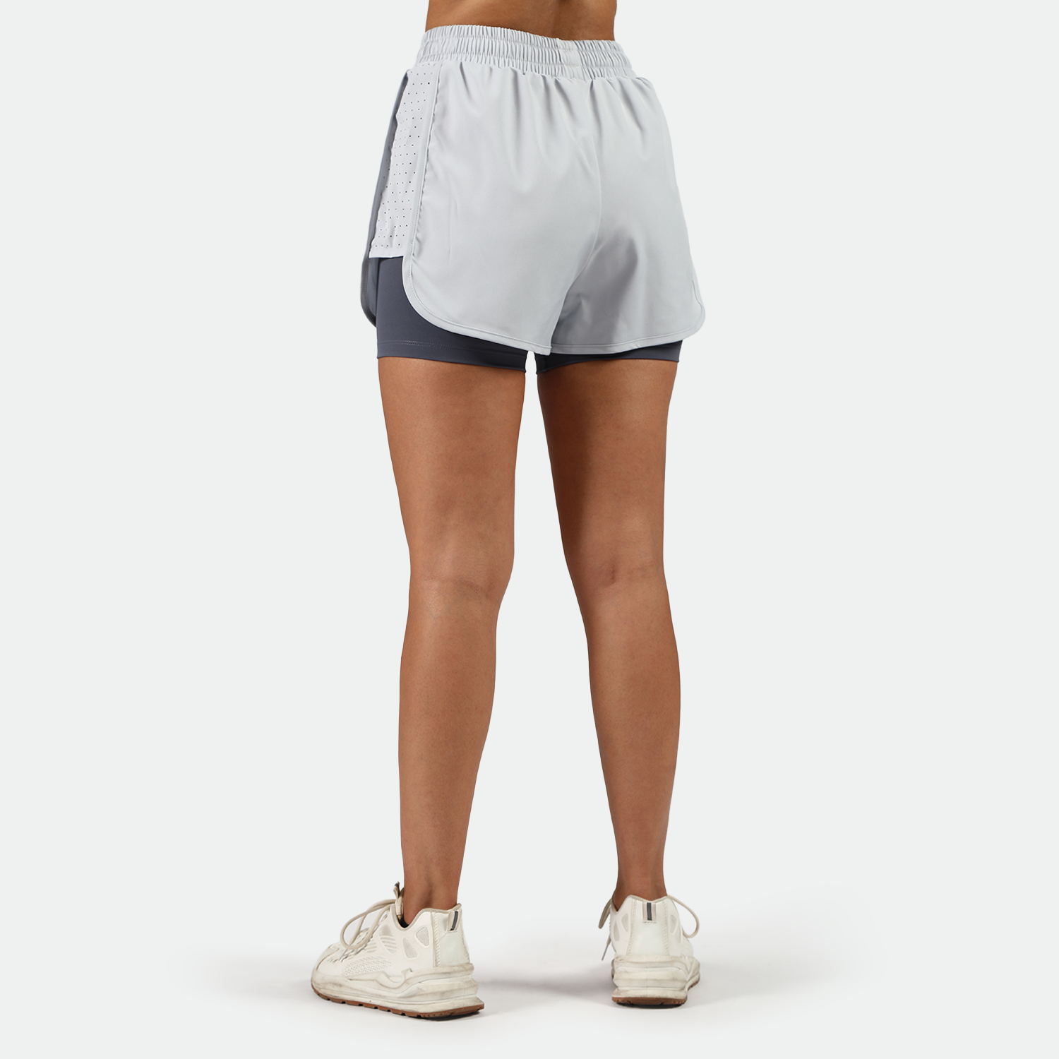 a back view for fit woman wearing  arctic ice blue short with shoes ,plus the background is light grey 
