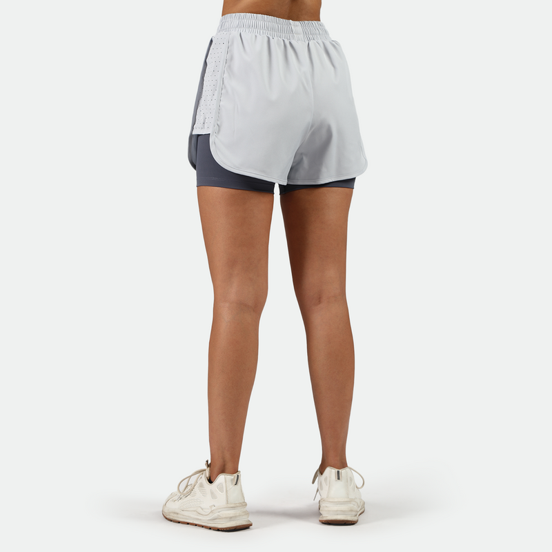a back view for fit woman wearing  arctic ice blue short with shoes ,plus the background is light grey 