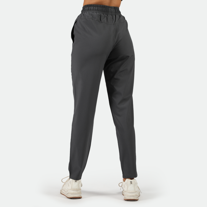 a back view for fit woman wearing shoes white ,plus the background is light grey 