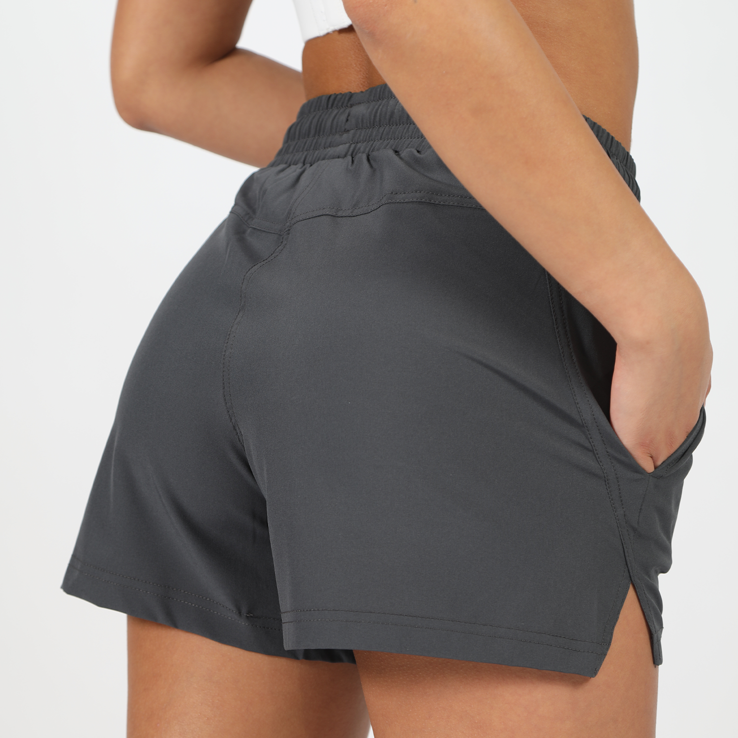 close up view for back view to girl wearing short grey ,plus the background is light grey 