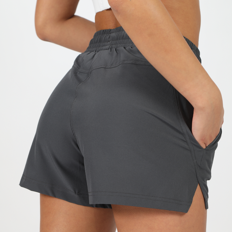 close up view for back view to girl wearing short grey ,plus the background is light grey 