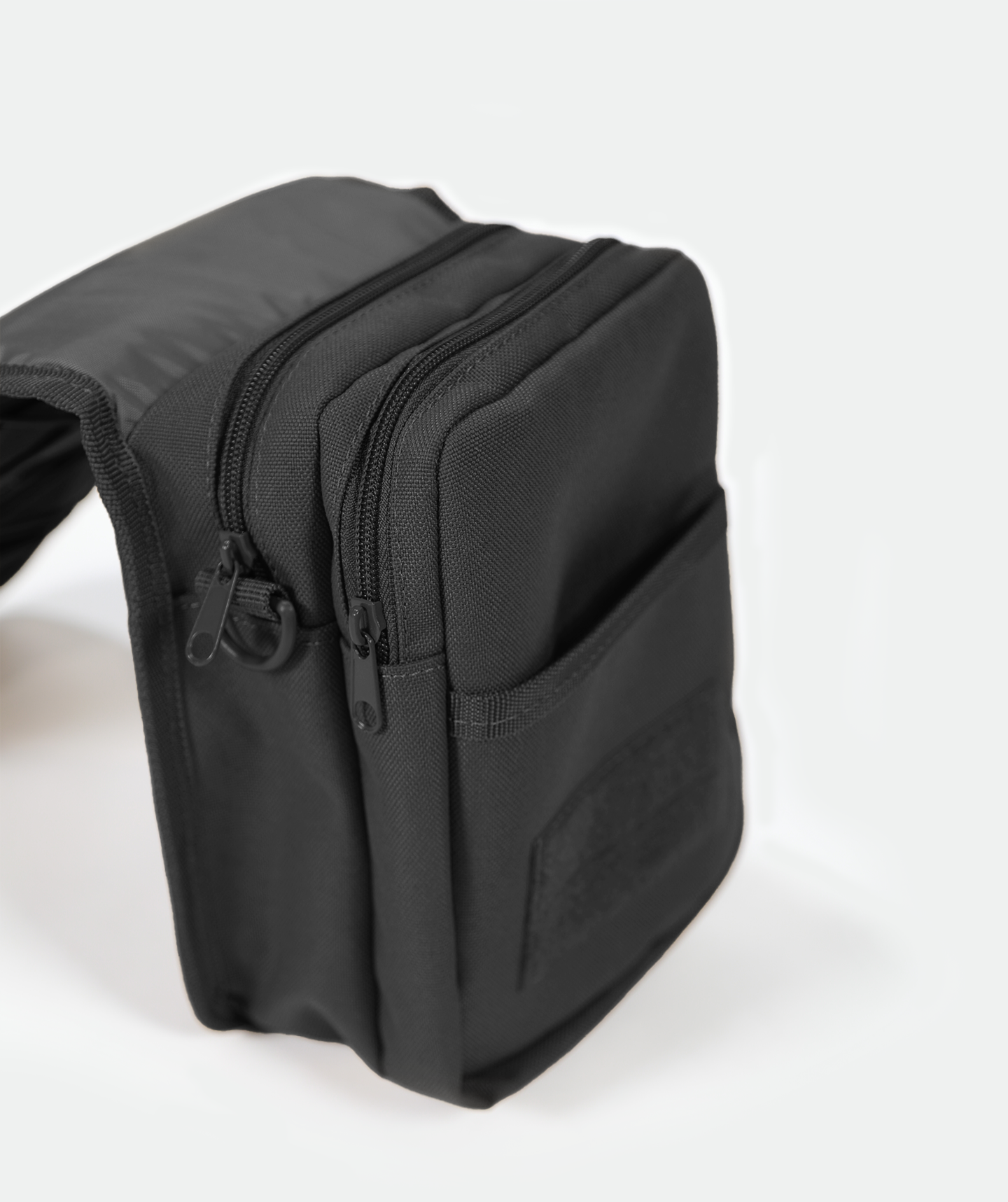 close up view for side for small, black crossbody shoulder bag with an adjustable strap with ,plus pocket black 