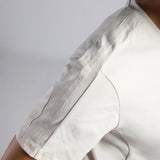 Close-up of a person wearing a white short-sleeve top, showing the sleeve with a repeating embossed 'winnerforce' brand name along the seam.