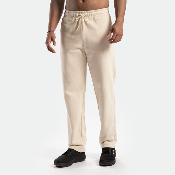 a fit man wearing  pants birch beige  with  shoes black 