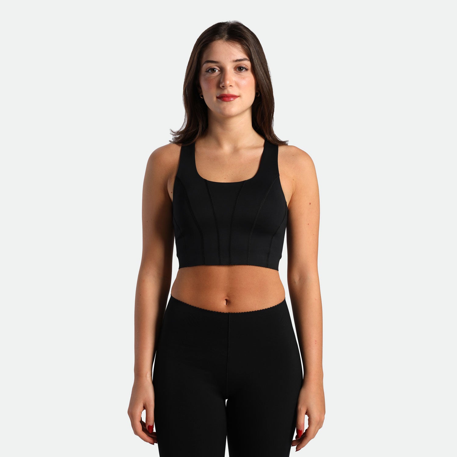 a fit woman wearing matching set black ,bra and legging 