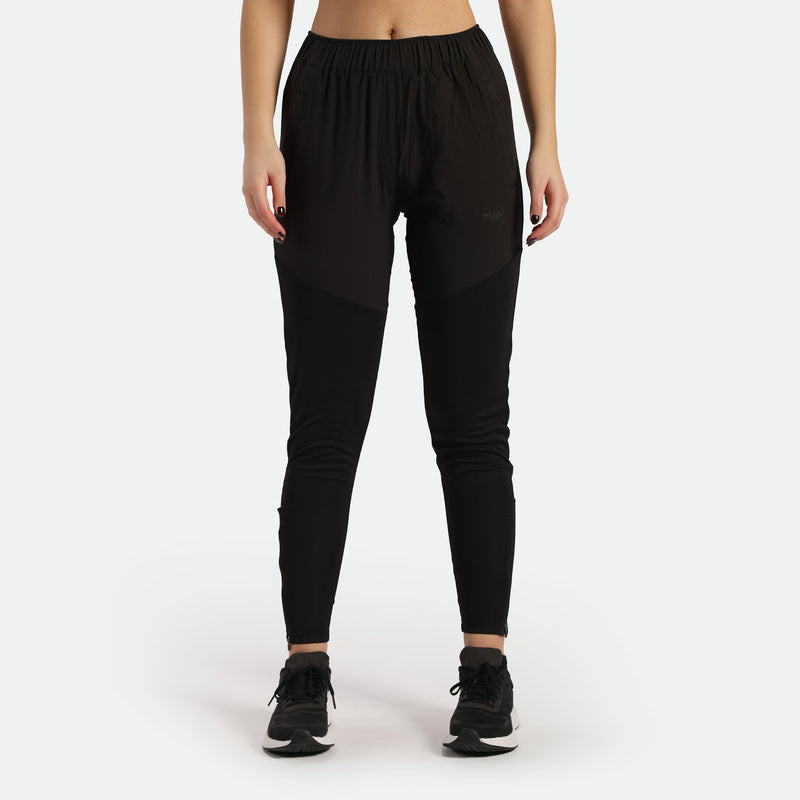 a fit woman wearing pants black with sneakers black 