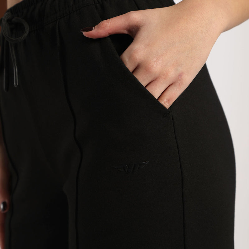 close up view for pocket of black jogger pants ,plus the background is light grey 