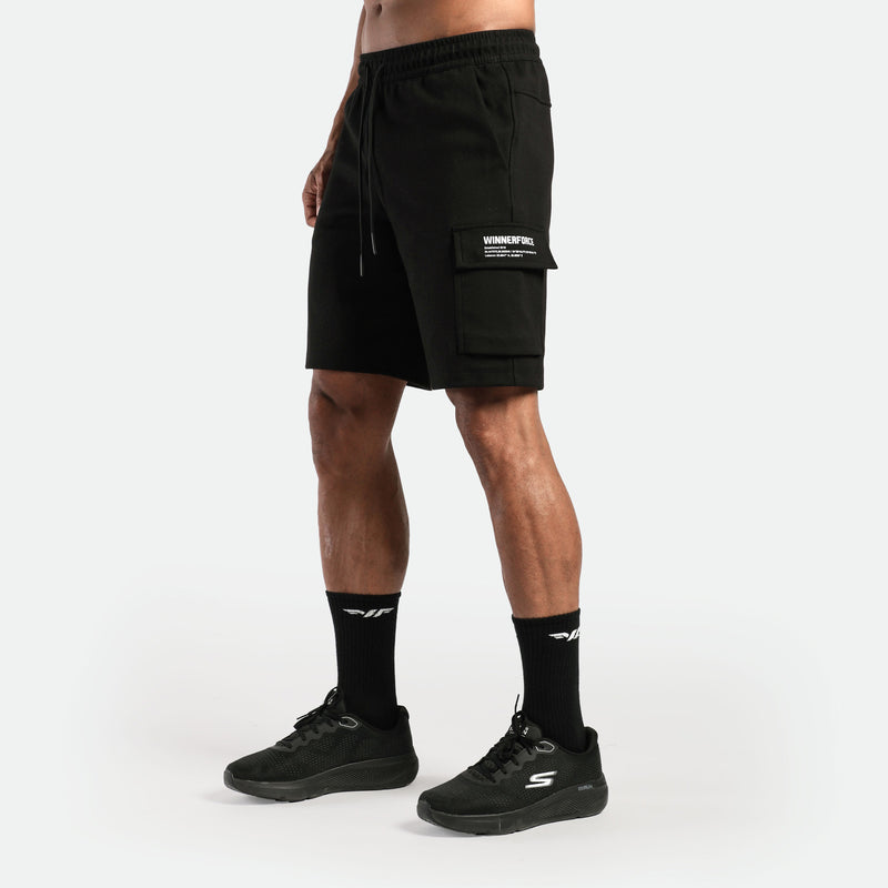 a fit man wearing short black with  pocket and logo ,plus the shoes and socks black 